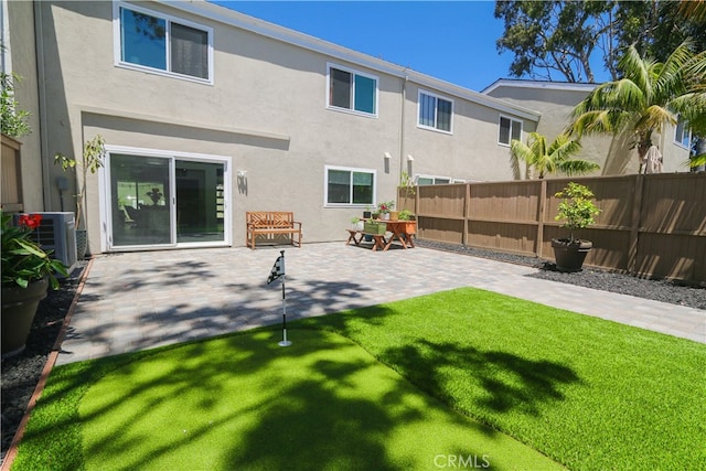 rear view of property with a patio and cooling unit