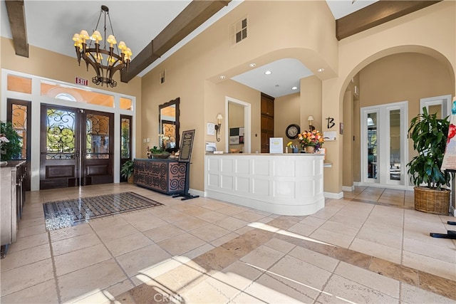 reception with french doors and a chandelier