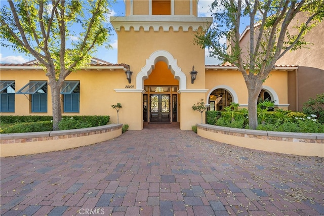 view of exterior entry featuring french doors