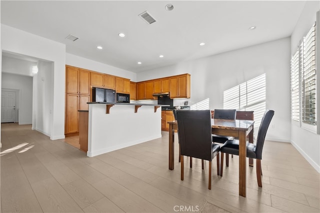 dining space featuring light hardwood / wood-style flooring