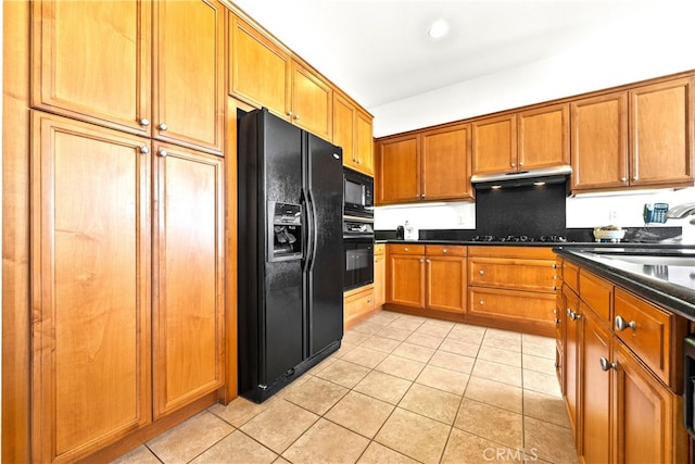 kitchen with black appliances, light tile patterned flooring, and sink