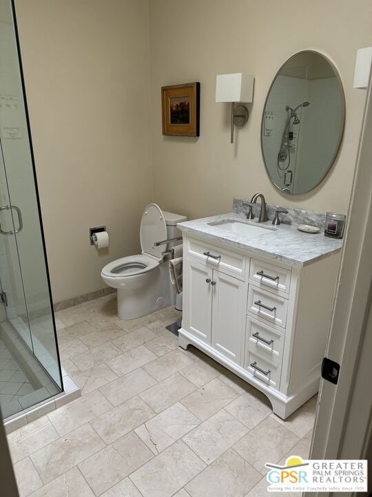 bathroom with vanity, an enclosed shower, and toilet