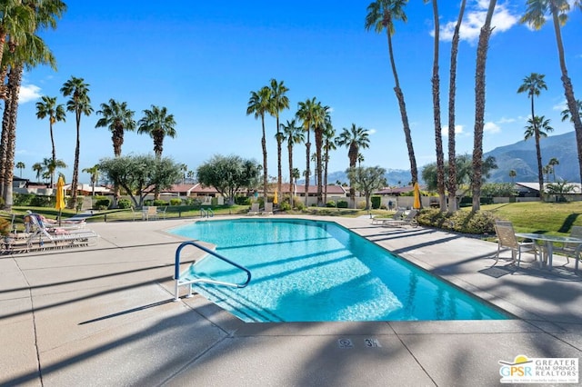 view of pool featuring a mountain view and a patio area