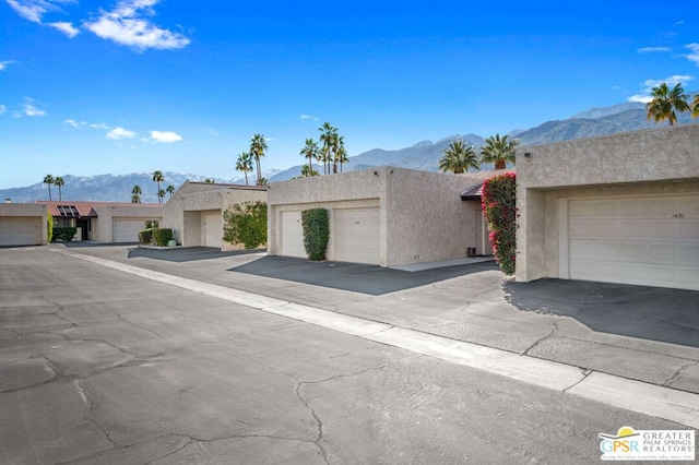 view of front of property featuring a mountain view and a garage