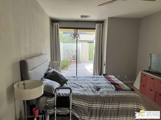 bedroom with access to outside and ceiling fan