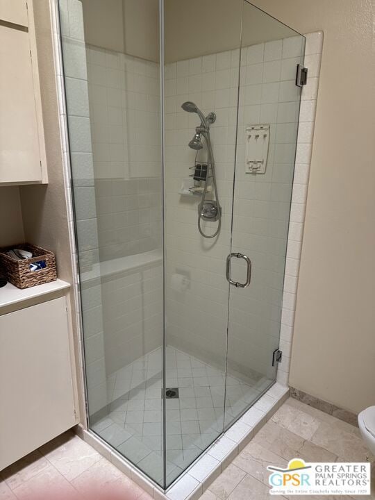 bathroom featuring toilet and walk in shower