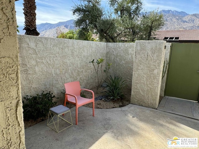 view of patio / terrace featuring a mountain view