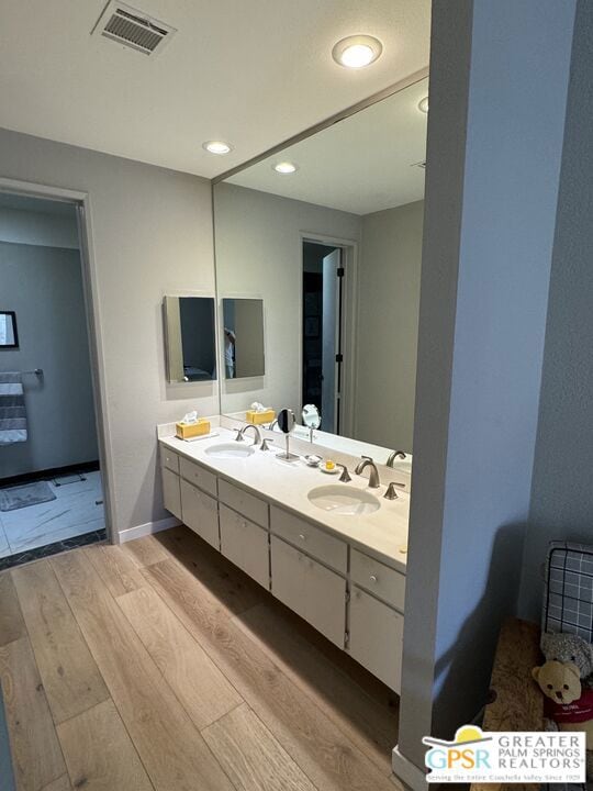 bathroom featuring vanity and wood-type flooring