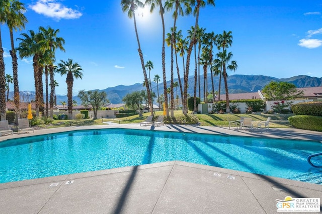 view of swimming pool featuring a mountain view and a patio