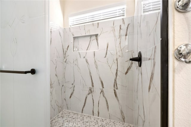 bathroom featuring tiled shower