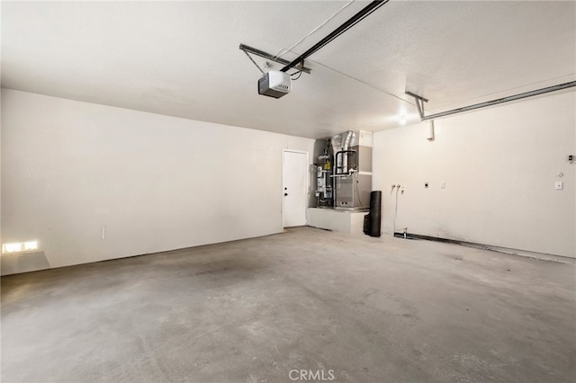 garage featuring a garage door opener, heating unit, and water heater