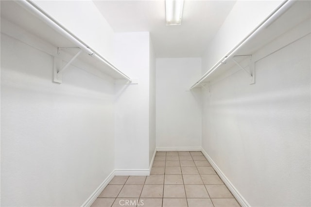 spacious closet featuring light tile patterned flooring