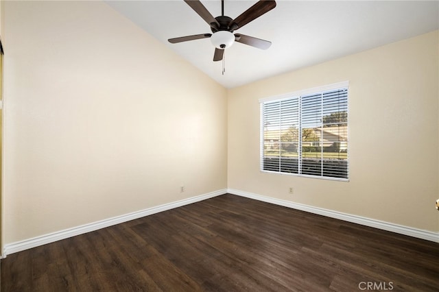 empty room featuring ceiling fan, dark wood-type flooring, and vaulted ceiling