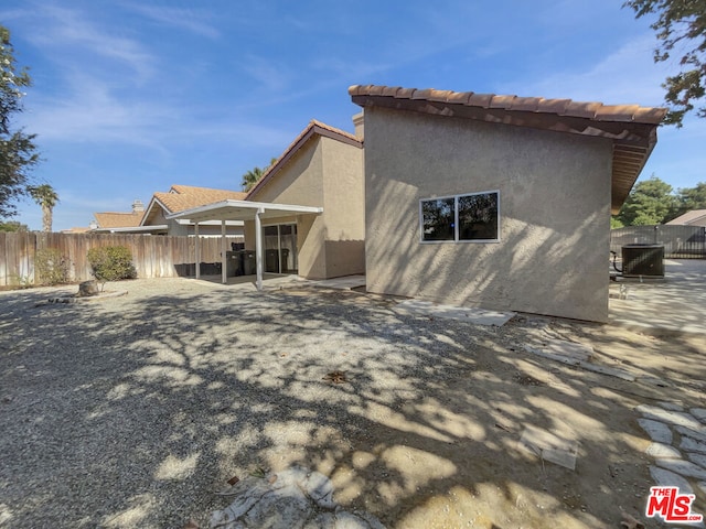 back of house with a patio and cooling unit