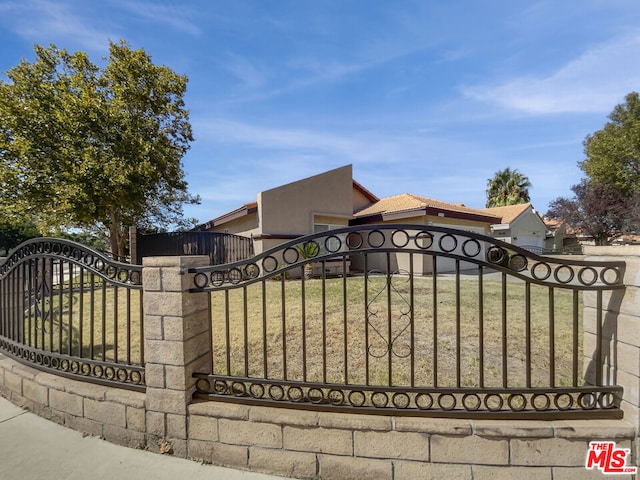 view of gate featuring a yard