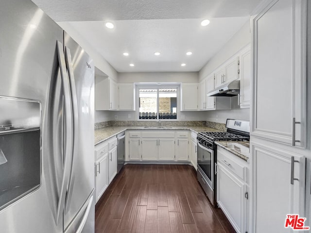 kitchen with stainless steel appliances, white cabinets, dark wood-type flooring, and sink