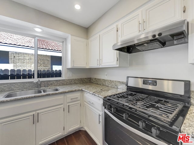 kitchen featuring dark hardwood / wood-style flooring, white cabinets, stainless steel range with gas cooktop, and sink