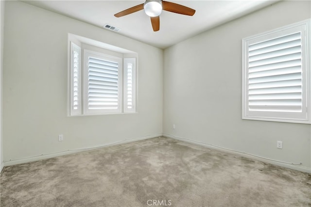 carpeted empty room with ceiling fan