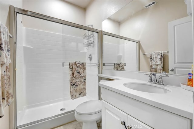 bathroom with walk in shower, vanity, and toilet