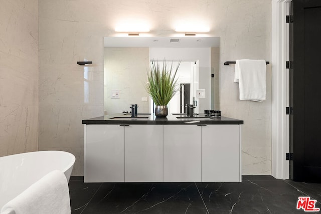 bathroom featuring a washtub and vanity