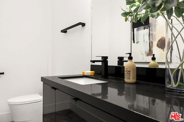 bathroom featuring tile patterned floors, vanity, and toilet