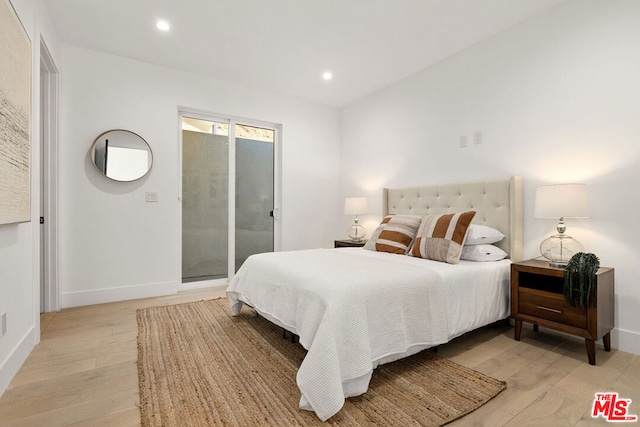 bedroom with access to outside and light hardwood / wood-style floors