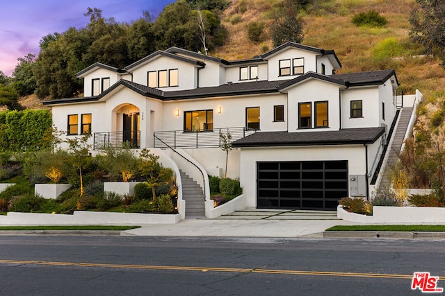 view of front of home featuring a garage and a balcony