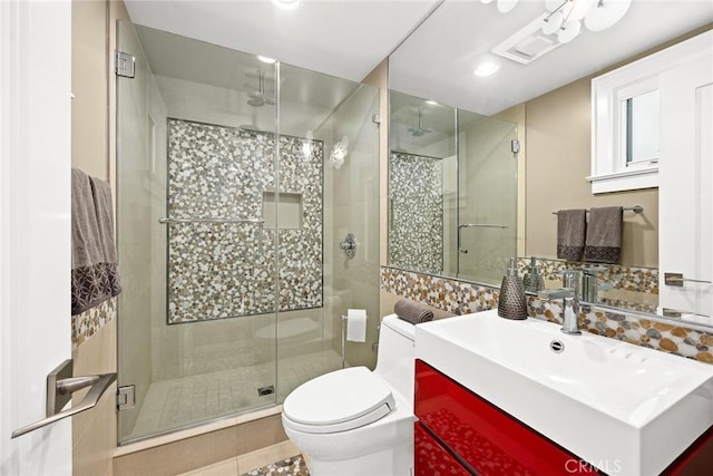 bathroom featuring an enclosed shower, vanity, toilet, and tile patterned flooring