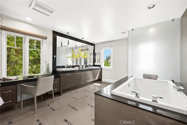 bathroom featuring a tub and vanity