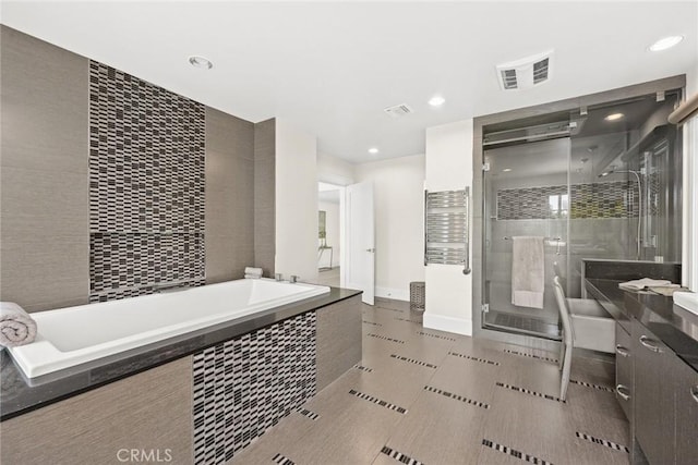 bathroom featuring vanity and plus walk in shower