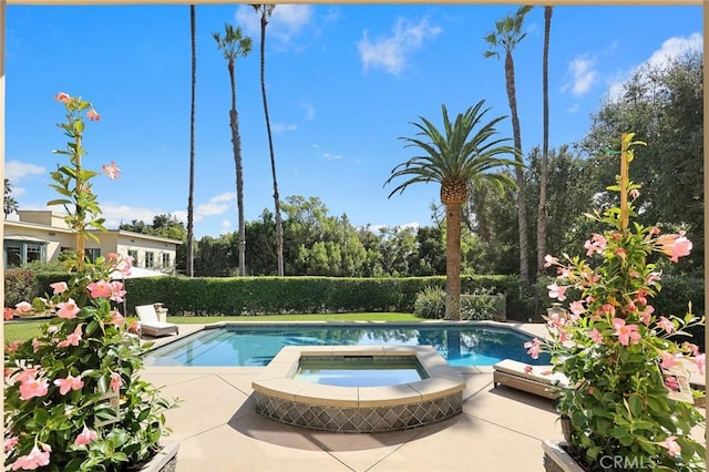 view of swimming pool featuring an in ground hot tub and a patio area