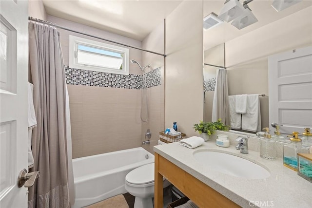 full bathroom with shower / tub combo with curtain, vanity, and toilet