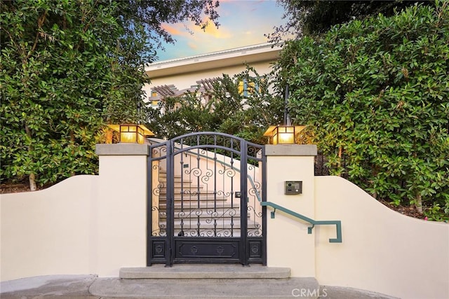 view of gate at dusk