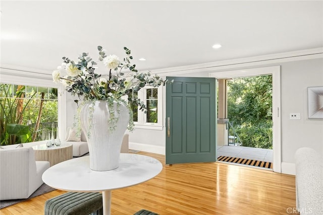 dining space with plenty of natural light, light hardwood / wood-style floors, and crown molding