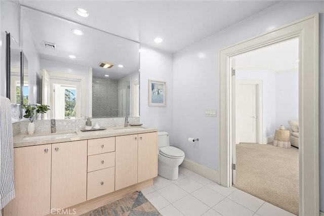 bathroom featuring tile patterned flooring, vanity, toilet, and a shower with shower door