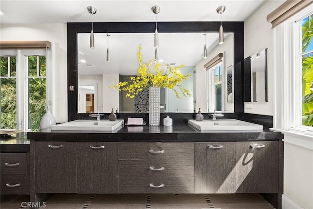 bathroom with vanity and a wealth of natural light