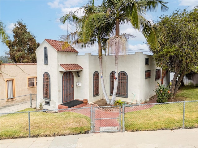 mediterranean / spanish-style home with a front yard