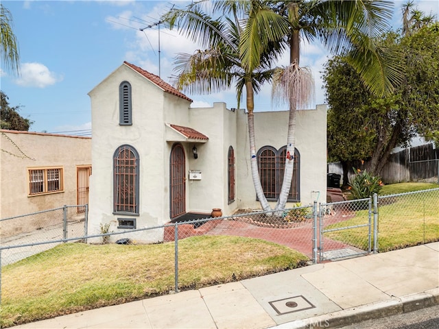 mediterranean / spanish house with a front lawn