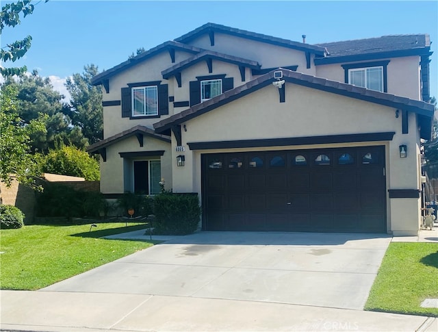 craftsman house with a garage and a front lawn