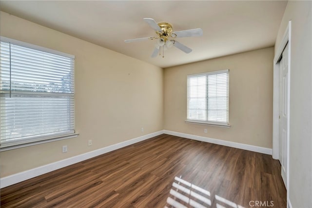 unfurnished bedroom with a closet, ceiling fan, and dark hardwood / wood-style flooring