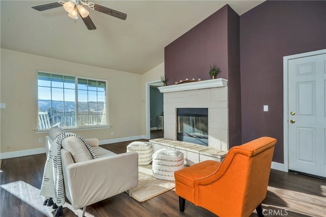 living room featuring lofted ceiling, dark hardwood / wood-style floors, and ceiling fan