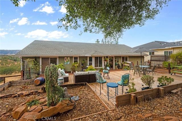 rear view of property with an outdoor hangout area and a deck