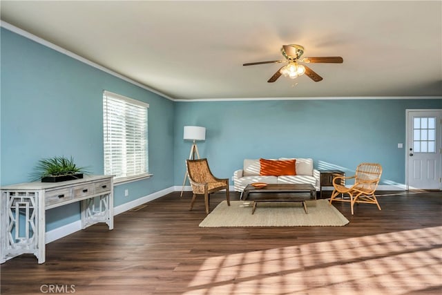 living area featuring crown molding, ceiling fan, and dark wood-type flooring