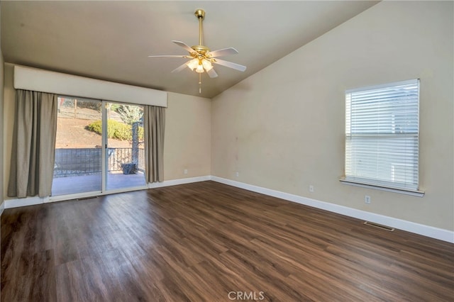 spare room featuring vaulted ceiling, ceiling fan, and dark wood-type flooring