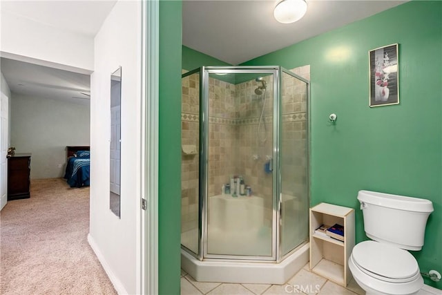 bathroom with toilet, tile patterned flooring, and a shower with door