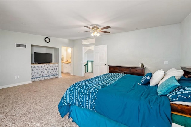 bedroom featuring ceiling fan, ensuite bathroom, and carpet flooring