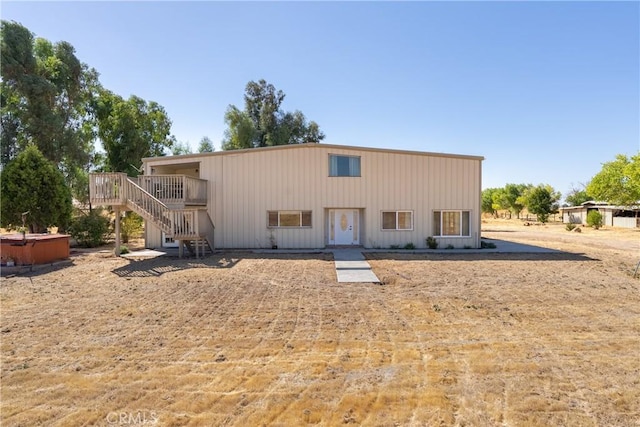 back of house featuring a wooden deck