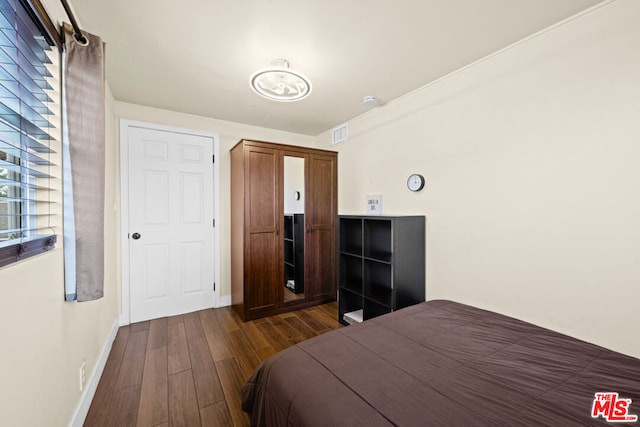 bedroom featuring dark hardwood / wood-style flooring