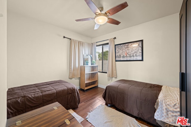 bedroom featuring ceiling fan and dark hardwood / wood-style flooring