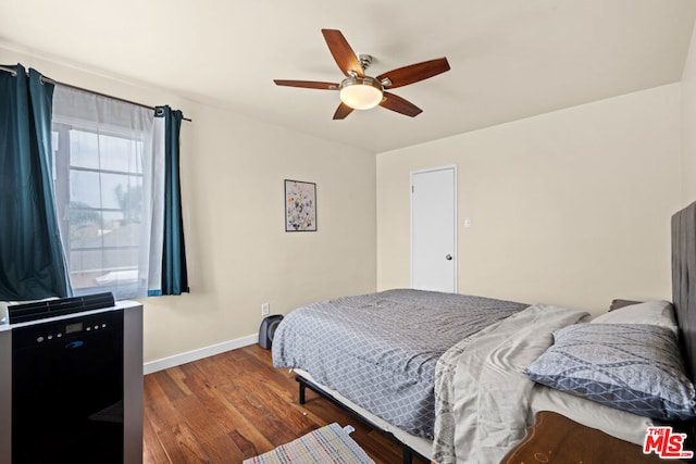 bedroom featuring dark hardwood / wood-style flooring and ceiling fan